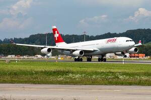 Swiss International Airlines passenger plane at airport. Schedule flight travel. Aviation and aircraft. Air transport. Global international transportation. Fly and flying. photo