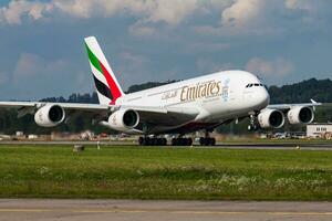 Emirates Airlines passenger plane at airport. Schedule flight travel. Aviation and aircraft. Air transport. Global international transportation. Fly and flying. photo