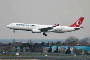 Turkish Airlines Airbus A330-300 TC-LOE passenger plane landing at Istanbul Ataturk Airport photo