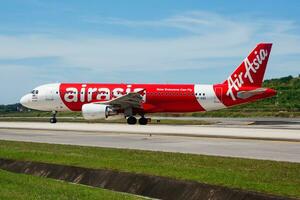 AirAsia passenger plane at airport. Schedule flight travel. Aviation and aircraft. Air transport. Global international transportation. Fly and flying. photo