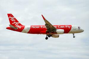 AirAsia passenger plane at airport. Schedule flight travel. Aviation and aircraft. Air transport. Global international transportation. Fly and flying. photo