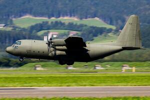 Untitled military transport plane at air base. Airport and airfield. Air force and army flight operation. Aviation and aircraft. Air lift. Military industry. Fly and flying. photo