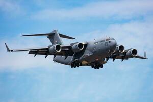 Military transport plane at air base. Air force flight operation. Aviation and aircraft. Air lift. Military industry. Fly and flying. photo