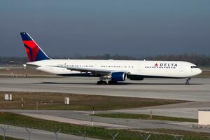 Delta Airlines passenger plane at airport. Schedule flight travel. Aviation and aircraft. Air transport. Global international transportation. Fly and flying. photo