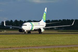 Transavia passenger plane at airport. Schedule flight travel. Aviation and aircraft. Air transport. Global international transportation. Fly and flying. photo