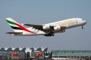 Emirates passenger plane at airport. Schedule flight travel. Aviation and aircraft. Air transport. Global international transportation. Fly and flying. photo