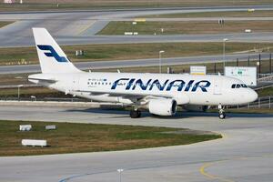 Finnair passenger plane at airport. Schedule flight travel. Aviation and aircraft. Air transport. Global international transportation. Fly and flying. photo