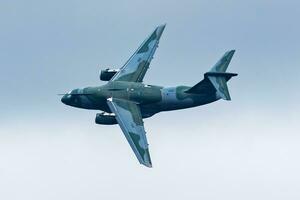 Embraer KC-390 Millennium. Military transport plane at air base. Air force flight operation. Aviation and aircraft. Air lift. Military industry. Fly and flying. photo