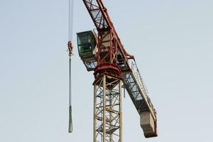 Tower crane. Construction site. Building industry. Tall and heavy machine. Industrial usage. photo