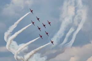 Aerobatic team at airshow. Flight demonstration and formation flying. Air force and military show. Airport and air base. Aviation and aircraft. Fly and flying. photo