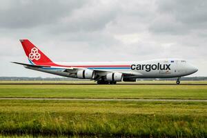 Cargolux cargo plane at airport. Air freight and shipping. Aviation and aircraft. Transport industry. Global international transportation. Fly and flying. photo