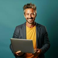 Portrait of a smiling mature man using laptop photo