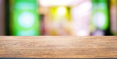 Empty wooden table in front of abstract blurred background of coffee shop . can be used for display or montage your products.Mock up for display of product. photo