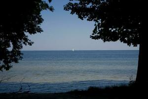 landscape with a sailing ship sailing on the blue Baltic Sea photo