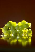 bunch of green grapes with wooden plinth isolated light from behind, indoor studio photo
