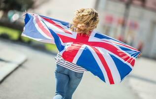 Attractive happy young girl with the flag of the Great Britain photo
