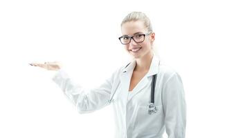 Portrait of a young beautiful woman doctor holding product isolated on white photo