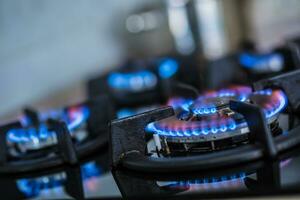 Close-up kitchen stove cook with blue flames burning photo