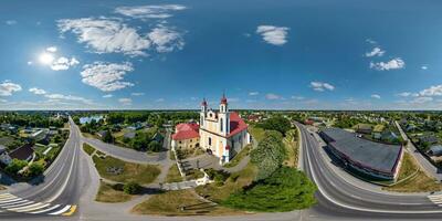 full hdri 360 panorama aerial view on red brick neo gothic or baroque catholic church in countryside or village in equirectangular projection with zenith and nadir. VR  AR content photo