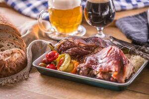 Bavarian knee traditional german czech slovak and austrian delicious food. Smoked roasted pork meat with draft beer photo