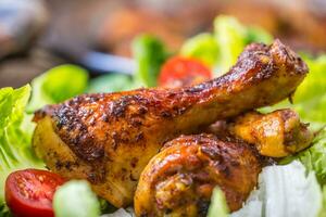 Grilled chicken legs lettuce and cherry tomatoes. Traditional cuisine. Mediterranean cuisine photo