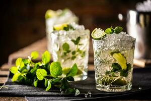 Mojito or virgin mojito long rum drink with fresh mint, lime juice, cane sugar and soda photo