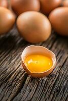 Fresh raw eggs on rustic wooden table photo