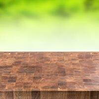 Empty wooden table and montage green summer background photo