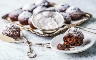 Homemade bakery and sweet muffins with powdered sugar photo