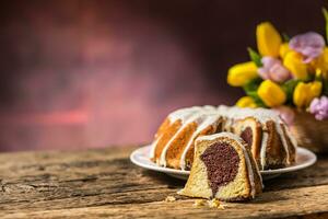 Pascua de Resurrección pastel. tradicional anillo mármol pastel con Pascua de Resurrección decotación Pascua de Resurrección huevos y primavera tulipanes foto