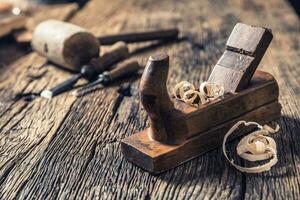 Old planer and other vintage carpenter tools in a carpentry workshop photo
