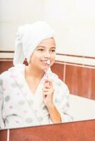 Teenage girl in bathroom with toothbrush. Morning and evening dental hygiene photo