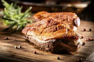 Roasted duck breast on a cutting board ready for slicing and serving photo