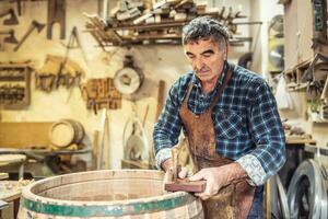 Wooden barrels manufacturer finished the building of another product with his own hands photo