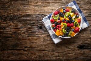 Fruit fresh mixed tropical fruit salad. Bowl of healthy fresh fruit salad - died and fitness concept. photo