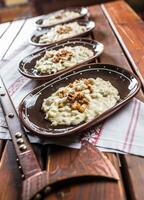 Traditional slovakian food Halusky with fried bacon and decoration photo
