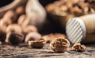 Walnut kernels whole walnuts in burlap sack and vintage bowl photo