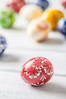 Close-up multicolored easter eggs on wooden table photo
