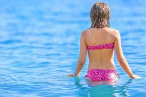Happy teen girl enjoing summer water and holidays in holiday destinations. photo