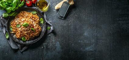 Pasta spaghetti toamto and bolognese sauce with oilve oil parmesan and basil photo