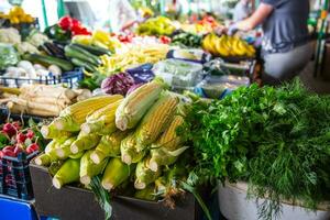 Various fruits and vegetables on the farm market in the city. Fruits and vegetables at a farmers market photo