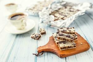 A waffle cake with caramel chocolate and walnuts.Traditional slovak and czech cake grilaz with coffee photo