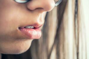 Closeup of beautiful young girl healthy lips photo