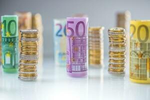 Rolled euro banknotes and coins towers stacked in other positions photo