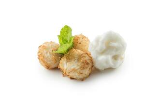 Traditional japanese fried sweet coconut balls with mint leaves and sorbet. photo