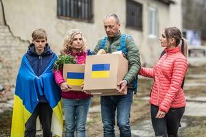 Vysne Nemecke, Slovakia. March 30. 2022. Ukrainian family accepts boxes of humanitarian help after Russia attacked Ukraine creating the crisis photo