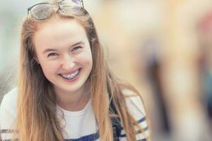 Portrait of a smiling beautiful teenage girl with dental braces photo