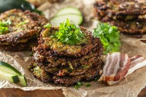 Crunchy zucchini pancakes with bacon parsley herbs and other ingredients photo