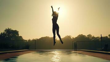 Athletic women doing high kicks by the pool in the morning mist. silhouette concept photo