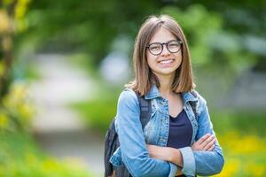 Portrait of attractive young teenage school girl with backpack photo